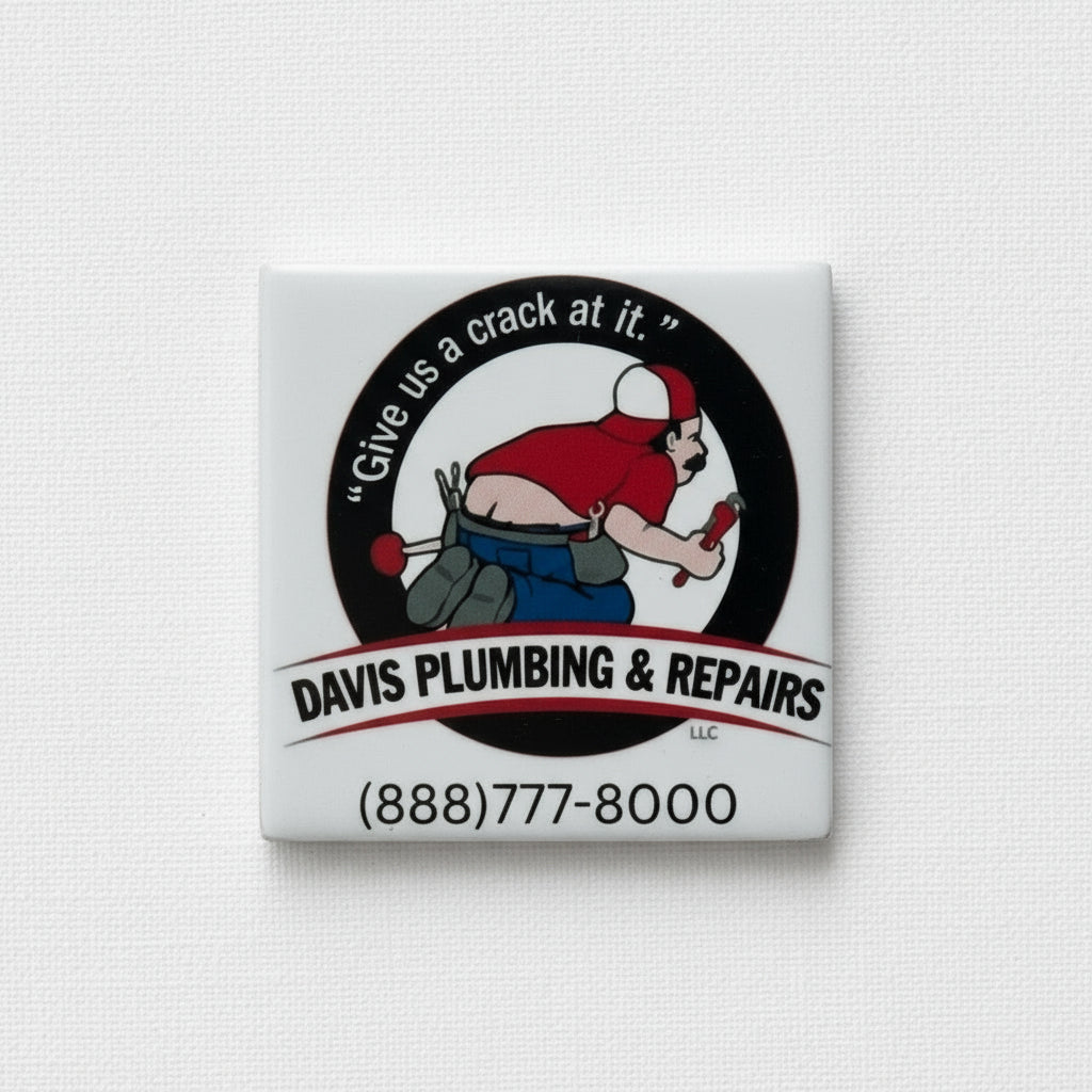 Magnet with 'Davis Plumbing & Repairs' logo and contact information on a refrigerator.