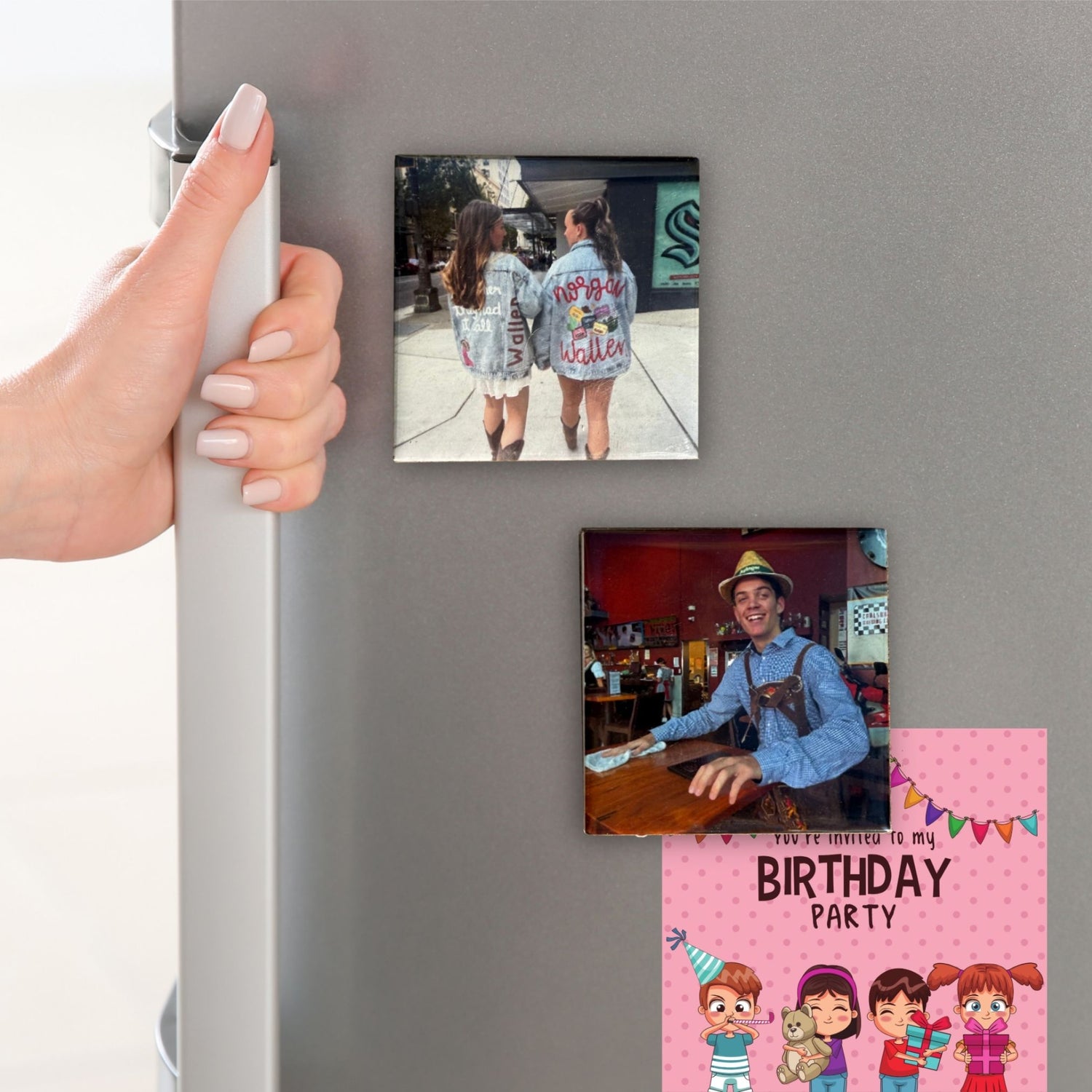 Fridge with photo magnets of people and a birthday party invitation on a refrigerator