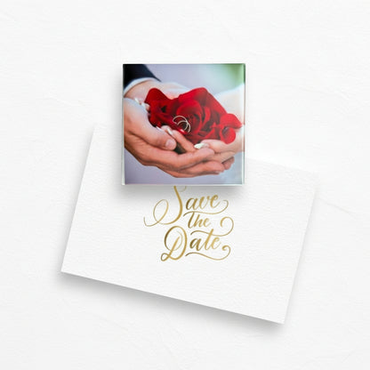 Fridge magnet with 'Save the Date' design featuring a red rose and hands holding a ring.